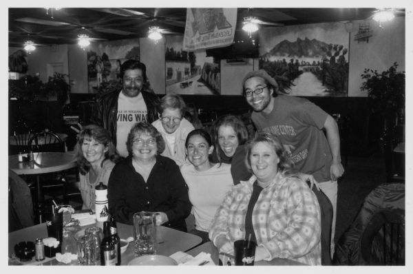 Group portrait of eight people posing at a table in a restaurant. Caption reads: "TERN [Tennessee Economic Renewal Network] Worker Exchange Reunion Tour: Dinner with our Mexican Allies Marco Antonio Torres and Nikki Thanos in Greeneville, Tennessee-October 2003."
