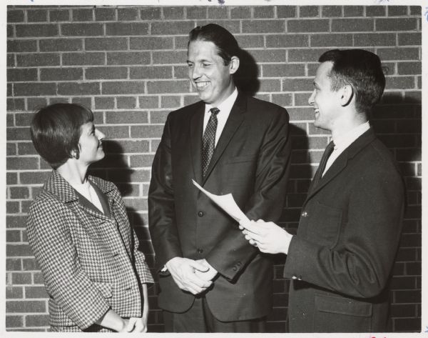 Three people stand together. Caption reads: "Mrs. Mary Williams, new Regent, Pres. James H. Albertson & Warren Kostroski Pres. of Student Senate relax after a conference."