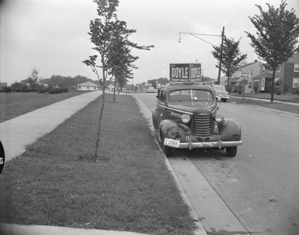 Caption reads: "Madison, Wis. "Doyle for Governor" car parking illegally on Midvale Boulevard."