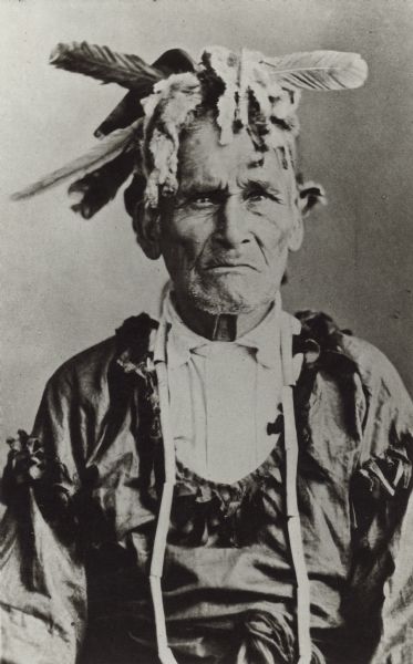 Waist-up portrait of a man. Caption reads: "Odinigun, Indian Story teller."