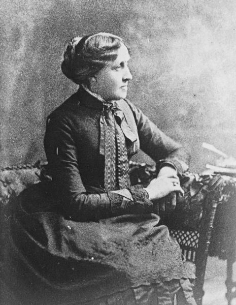 Seated profile portrait of American novelist Louisa May Alcott, author of <i>Little Women</i> and its sequels.