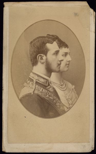 Oval framed quarter-length profile carte-de-visite portrait of Alfonso XII and Maria de las Mercedes, the King and Queen of Spain. 