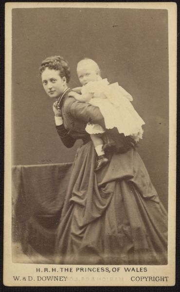 Carte-de-visite portrait of Alexandra, Princess of Wales, posing with a toddler on her back. This is probably her first-born son, Albert Victor.