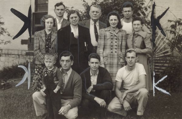 Four women, six men, and one boy pose together. Caption reads: "OFFICIALS AND NEGOTIATING COMMITTEE of Hosiery Branch 169 were instrumental in winning the recent labor board election at Portage Hosiery in Wisconsin. Shown, left to right, back row are, Theodore Paul, president; John Banachowicz, union representative; Carl Duffy, conductor. Middle row, June Paul, Lena Redding, Johanna VanderHoeck, trustee; Gladys Budde, secretary. Front row, Reinhold Budde, vice-president; Clarence VanderHoek, Robert Nehrlick."