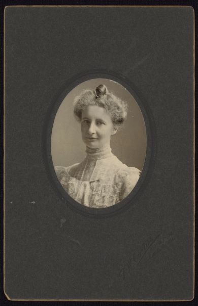 Oval-framed quarter-length carte-de-visite portrait of Katharine Allen, assistant professor of Latin at the University of Wisconsin-Madison. Katharine was the daughter of historian and UW-Madison classics professor William Francis Allen.