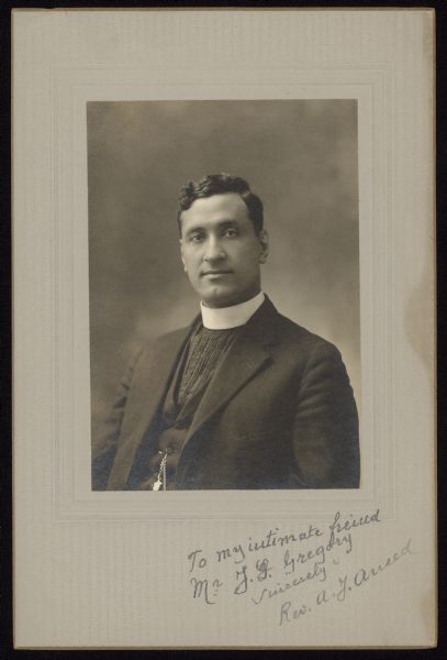 Waist-up portrait of Archbishop Anthony Joseph (Anton) Aneed, a Syrian immigrant and Exarch of the Archdiocese of Beirut. Reverend Aneed moved to Milwaukee and became second priest of Saint George’s Syrian Melkite Catholic Church. He received the title of Exarch in Milwaukee in 1918. In addition to his ministry at the Melkite Church, Exarch Aneed published <i>Syrian Christians: A Brief History of the Catholic Church of St. George in Milwaukee, Wisc. and a Sketch of The Eastern Church</i>. He also recorded songs on A.J. Macksoud’s record label in 1925. Later he served a number of Melkite churches around the United States.
Photograph includes a handwritten dedication: "To my intimate friend Mr. J.G. Gregory. Sincerely, Rev. A.J. Aneed."