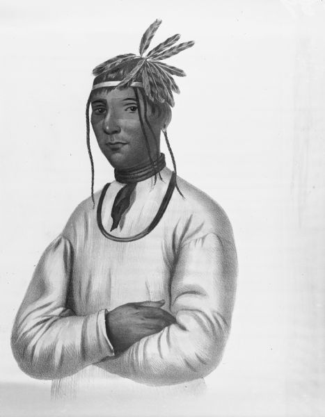 Waist-up portrait of a man with a feathered hat and scarf or kerchief. Identified as "Cao Tou See, an Ojibwa."