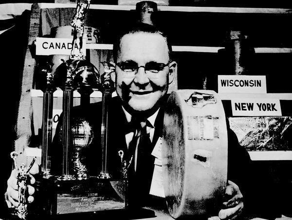 Ronald E. Johnson of Mount Sterling, with world champion cheddar cheese at the Wisconsin Cheese Makers Association Contest.