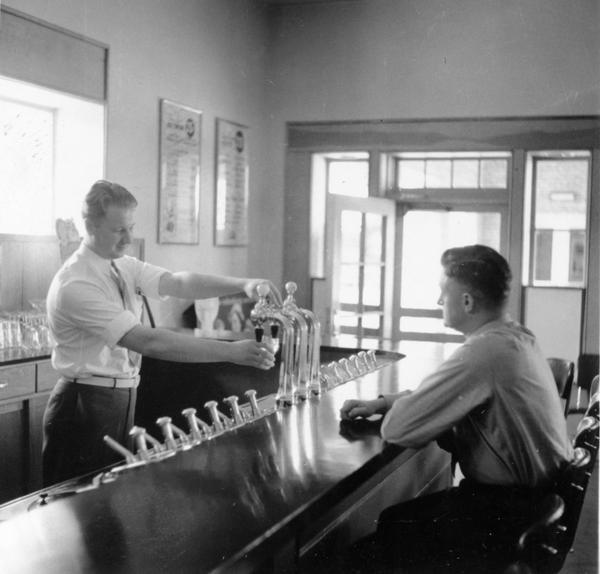 There were several businesses in Greendale, including a Co-op grocery store, variety store, post office, movie theater and a doctor and dentist office. There was also a drugstore with a soda fountain. This is Kendall Des Jardin's drugstore on Broad Street.