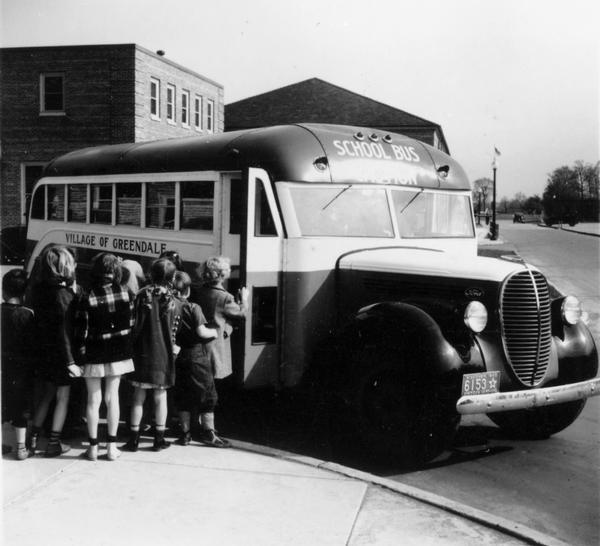 Group of children boarding school bus.