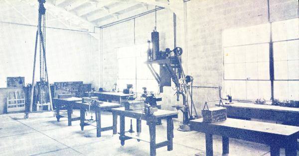 Interior view of the shop in Eilert Farm Equipment Company, showing the drill press and the big vise, in the center.