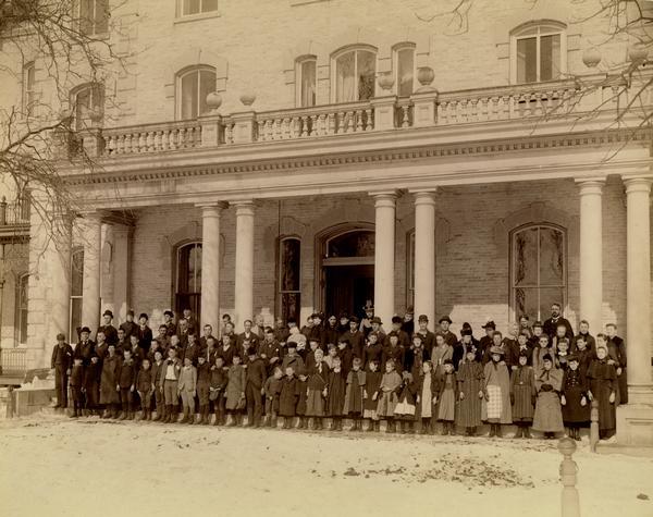 Students and adults of the State School for the Blind pose for a group portrait in front of the building.