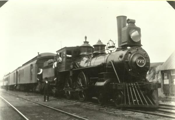 Chicago, Milwaukee, and St. Paul Railway engine #542, class H4, built by Schenectady Locomotive Works in 1882. Renumbered 773 In April of 1899, 226 in October of 1912, and scrapped on September 28, 1918. The train is shown here ready to leave for Milwaukee. Conductor Henry F. Durbin is on the ground by the engine, Engineer William H. Ellis is in the cab window and Fireman Charles E. Milles is in the gangway.