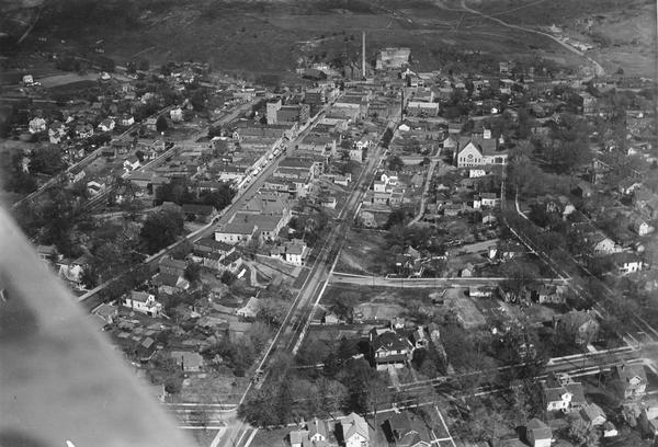 Aerial photograph taken as part of a survey by the Wisconsin Power and Light Company to promote economic development by emphasizing available buildings and building sites.