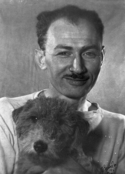 Edmund Eisenscher (1909-1995), posing with his dog.