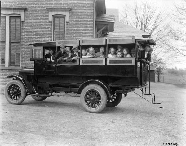 International Model S truck with bus body by Wayne Works carrying school children.
