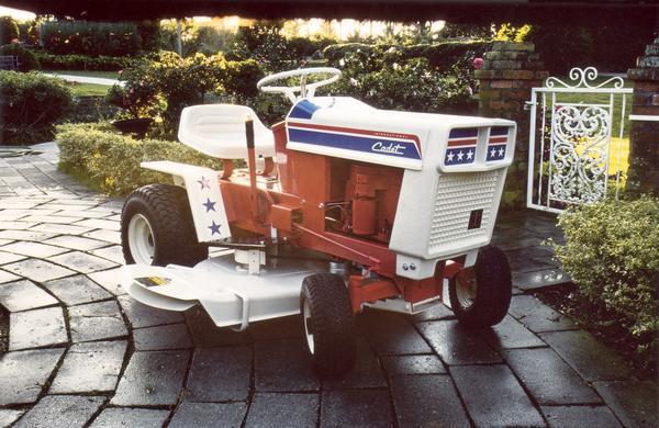 Color publicity shot of a red, white and blue International Harvester Cub Cadet lawn tractor produced for the Bicentennial of the United States. The tractor was named "Spirit of '76".