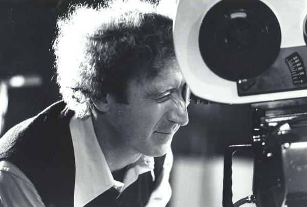 Gene Wilder looking through the lens of a movie camera.