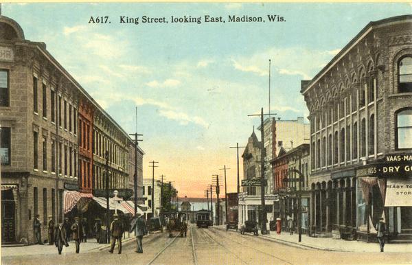 Colorized view of King Street, looking east, with a streetcar. Lake Monona is in the background. Caption reads: "King Street, looking East, Madison, Wis."