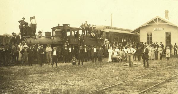 Fairchild and Northeastern Railroad depot, with first train into Willard on the Fairchild and Northeastern Line.