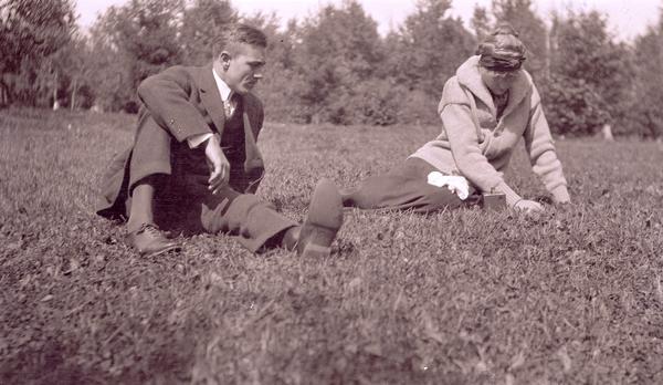 Leo W. Capser and Margaret Glover (Mrs. Andrews) lounging on the grass in the Apostle Islands.