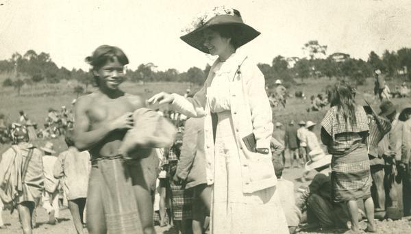 Trading market; Bajiou, Philippines. Image of boy with notation: "Native Bajiou (P.I.) giving Jane his hat." Second of a sequence of three images.