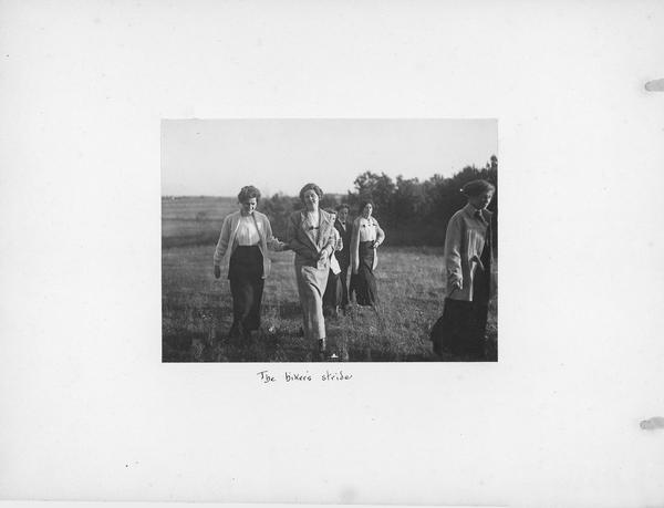 Five young women walking across a field. The hand-lettered caption reads: "The hiker's stride."