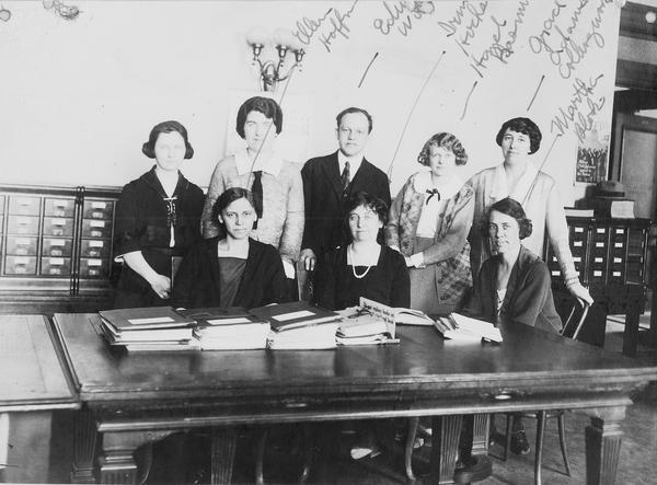 Staff of the Wisconsin Legislative Reference Library. Several are identified including Ellen Hoffman, Irene Hocks, Hazel Basem, Grace Adams, and Martha Blok. Edwin Witte is in the middle.