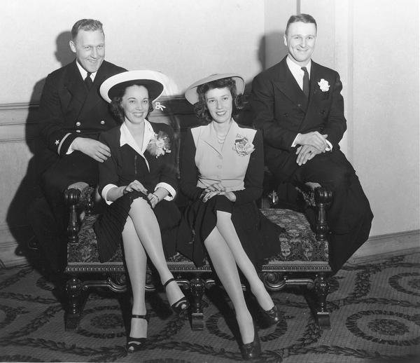 Portrait of bride Arlene Tiedeman and groom Edward Jankowski, U.W. and Green Bay football star, and Lorraine Tiedeman, bride's maid and Charles Pasch, best man, after the wedding ceremony at Blessed Sacrament Church, 2119 Rowley Avenue. 
