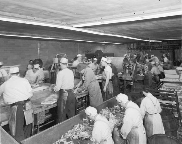 Men and women packing poultry at the Home Packing Company.