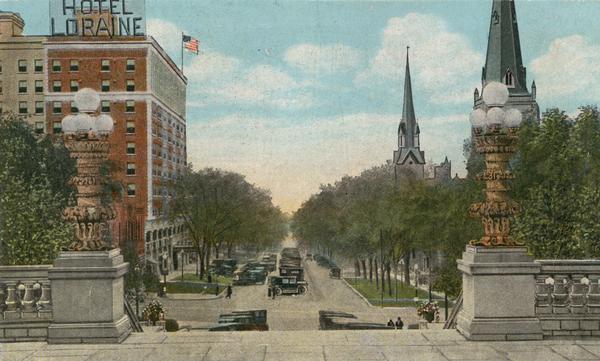 Color illustration of a view from the Wisconsin State Capitol (which was the fourth State Capitol and the third in Madison) showing the Hotel Loraine and West Washington Avenue.