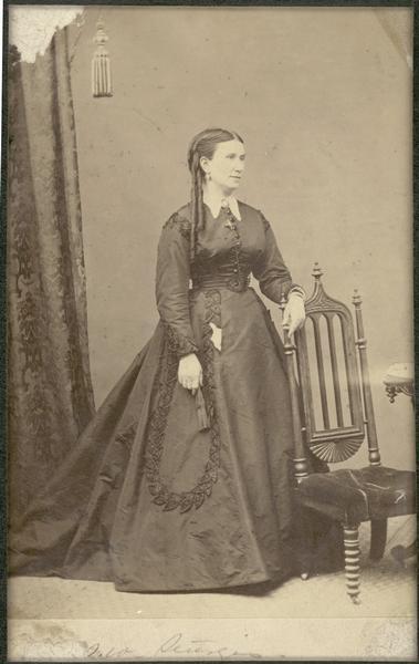 Full-length portrait of Jerusha Sturgis, standing near a chair. The wife of Samuel Davis Sturgis I and mother of Nina Dousman. Born December 1, 1827; Died July 4, 1915.