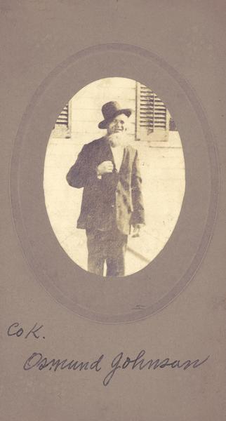 Candid portrait of Osmund Johnson as an older man, wearing his hat askew. He served in Company K of the 15th Wisconsin Volunteer Infantry. According to the "Roster of Wisconsin Volunteers" Johnson served as a Private; was a resident of Fillmore County, Minnesota when he enlisted on 11 February 1862, participated in the battles at Stone River and Chickamauga, was taken prisoner, and was mustered out on 30 May 1865. According to the 1900 Census he was born in Feb 1827 in Norway and immigrated in 1854. After the war he returned to Fillmore County to farm, and died there 1 October 1906.