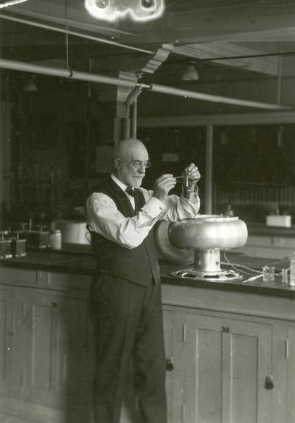 Dr. Stephen Babcock with an electric centrifuge butterfat tester.