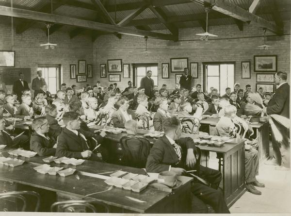Professor R. A. Moore lecturing to a group of boys at the UW-Madison College of Agriculture. Moore was a long-time director of short course work and a leader in organization of the Wisconsin Agricultural Experimental Association.