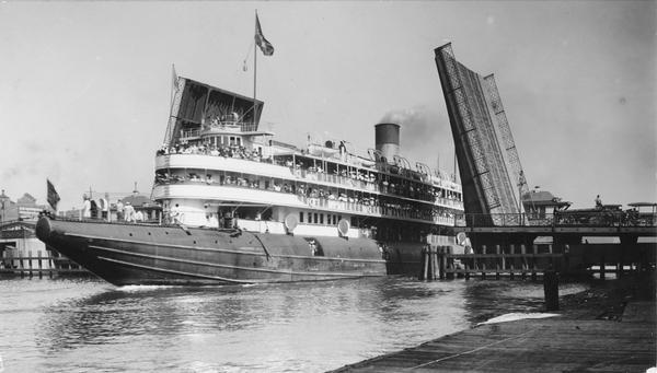 A screw passenger excursion vessel or whaleback, the <i>Christopher Columbus</i>, passing through the Broadway Bridge.