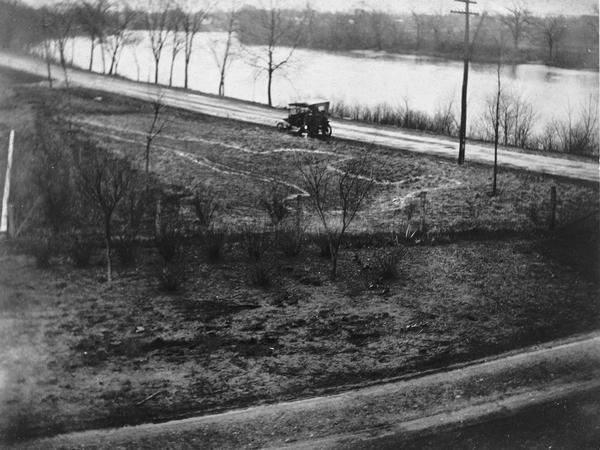 View of an Indian intaglio effigy, the only one still in existence in Wisconsin. The effigy is in the shape of a panther. There is a car on the road in the background.