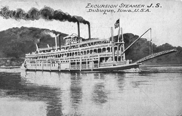 The sternwheel excursion, <i>J.S.</i> in the middle of the Mississippi River. The opposite shoreline is in the background.