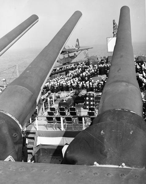 Elevated view of the USS <i>Wisconsin</i> Silver Presentation ceremony, with the ship's guns in the foreground.