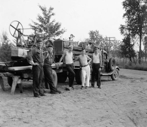 Five men, who are members of a fire fighting crew, pose in front of their truck at the Park Falls Ranger Station.