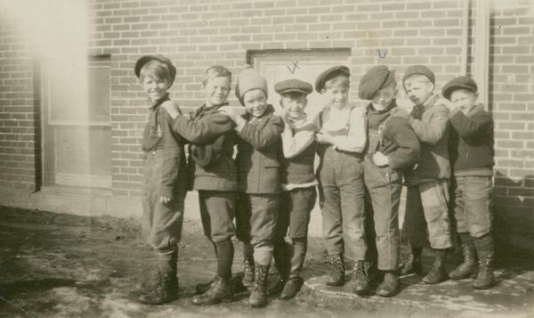 Eight young boys, including Sherman Benson, Don Finley and possibly Gaylord Nelson, pose together in a line.