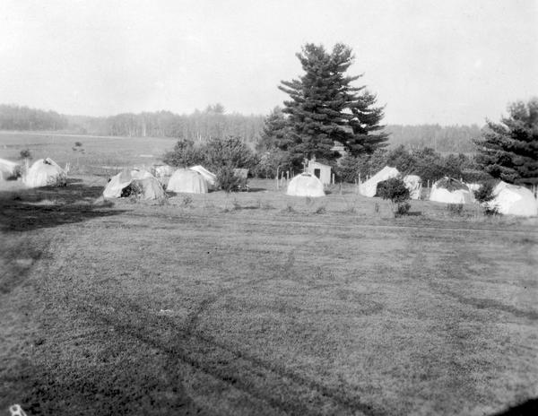 Elevated view of the J.J. Emmerich Cranberry Company showing the bog in the background with the Ho-Chunk (Winnebago) Indian cranberry pickers' camp at the edge of the bog.