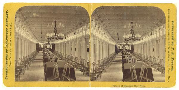 The saloon of the sidewheel excursion, "Red Wing." Chairs are lined up against the walls, spittoon are on the floor, and tables are covered with tablecloths. Caption reads: "Salooon of Steamer Red Wing."
