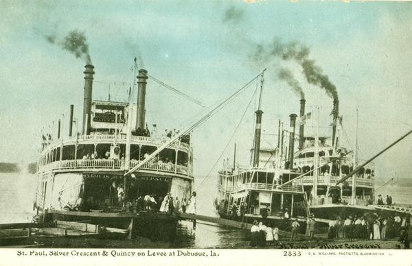 The <i>Saint Paul</i>, <i>Silver Crescent</i>, and <i>Quincy</i> at the levee. Gangplanks are lowered and passengers are disembarking. Caption reads: "St. Paul, Silver Crescent & Quincy on Levee at Dubuque, Ia."