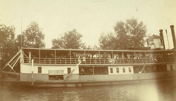 Side view of the sternwheel excursion, <i>Thistle</i> with her decks full of passengers. Previously named <i>J.H. Crawford</i>. The <i>Thistle</i> ran between Oshkosh and Omro, via Lake Butte des Morts.