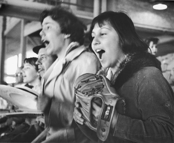 Close-up of fans shouting at a Milwaukee Braves baseball game.