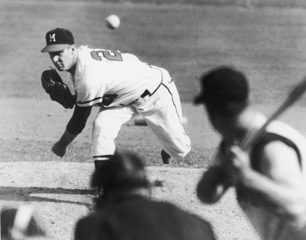Warren Spahn, famous left-handed pitcher of the Milwaukee Braves baseball team, completes a pitch to the batter.