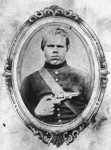 Portrait of Kittle Jordee of Company H, 27th Wisconsin Infantry, holding a revolver.