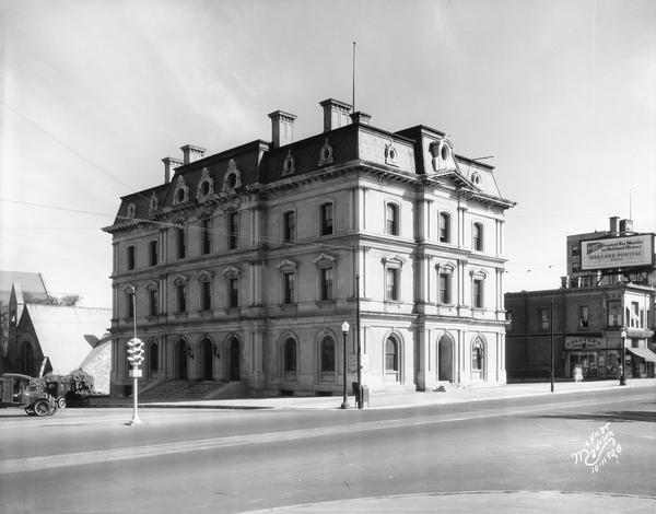 The old U.S. Post Office and Federal Building at 4 East Mifflin Street, just months before it was torn down and replaced by Manchester's Department store. The First Unitarian Society was located at 125 Wisconsin Avenue, to the left, and Collyer's Drugstore, 14 East Mifflin Street, to the right.