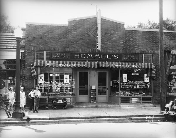 Exterior of the Hommel's Star Food Store at 606 South Park Street. Several children are on the sidewalk in the front. 
